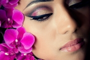 Closeup shot of a beautiful woman's face with orchid flowers